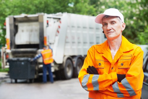Operative preparing for a house clearance job with protective gloves