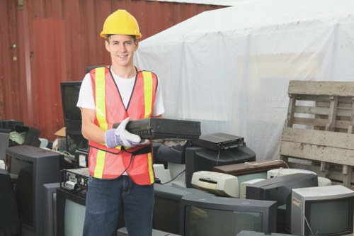 Workers organizing items during a house clearance at a suburban home