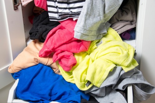 Man carrying bulky item down stairs during a maisonette clearance